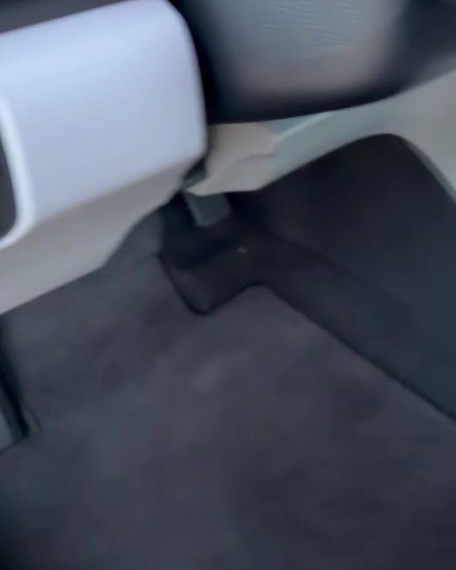 The same Honda's driver footwell with clean black carpet
