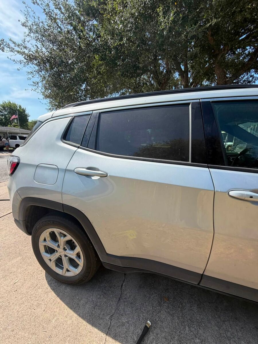 Clean doors and dark glass on a silver Jeep Compass