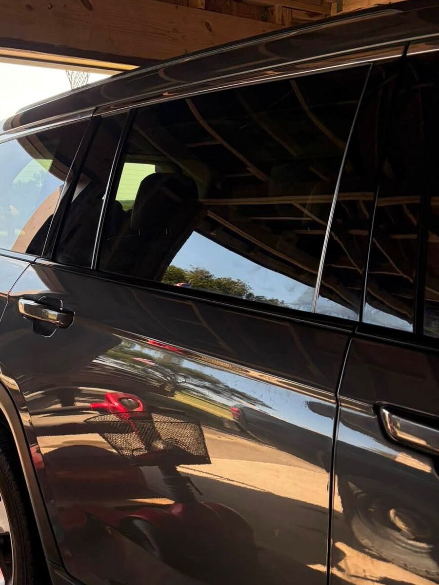 Grey Jeep SUV with glossy paint reflecting the carport