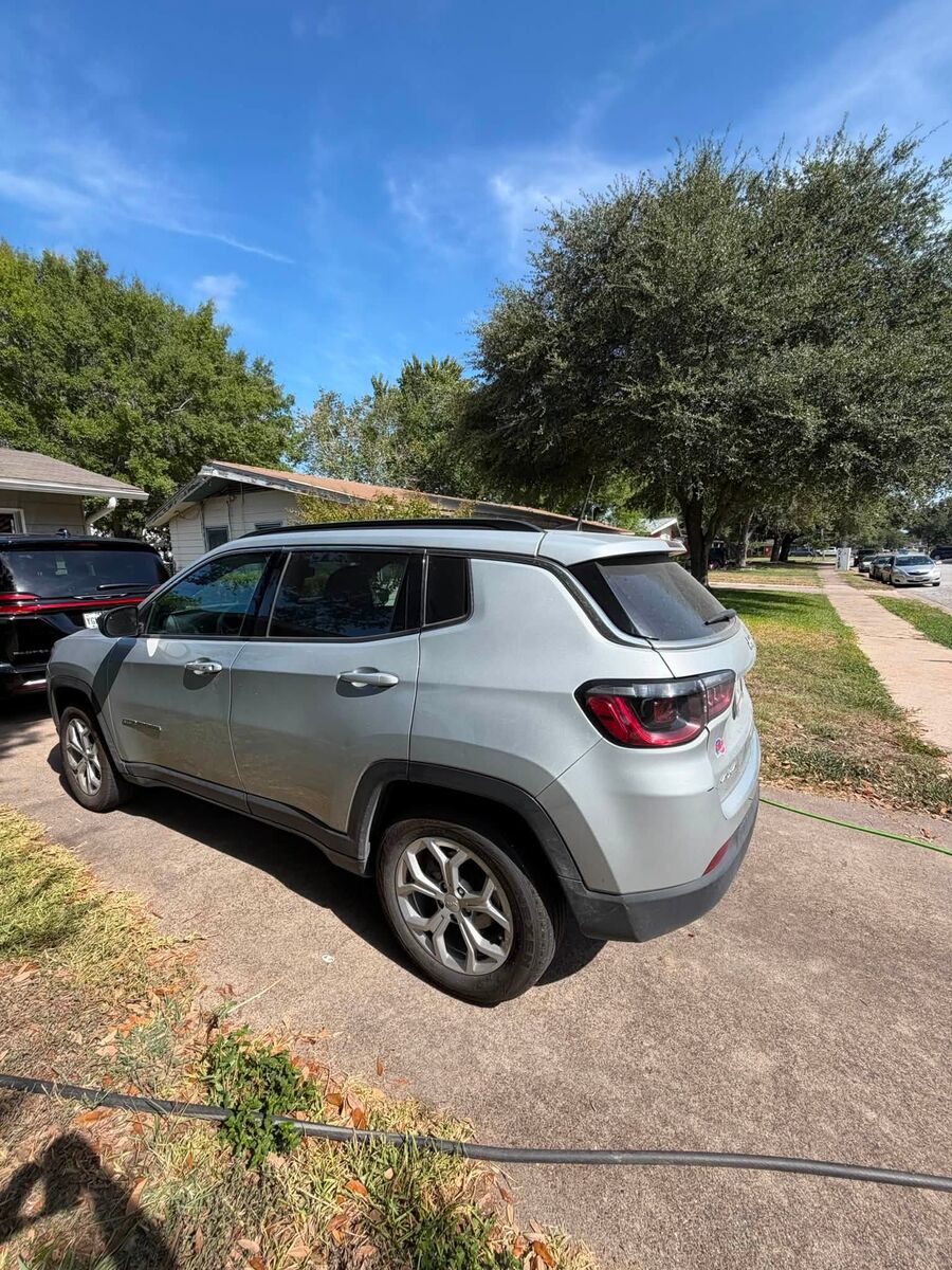 Rear three-quarter view of a clean silver Jeep Compass